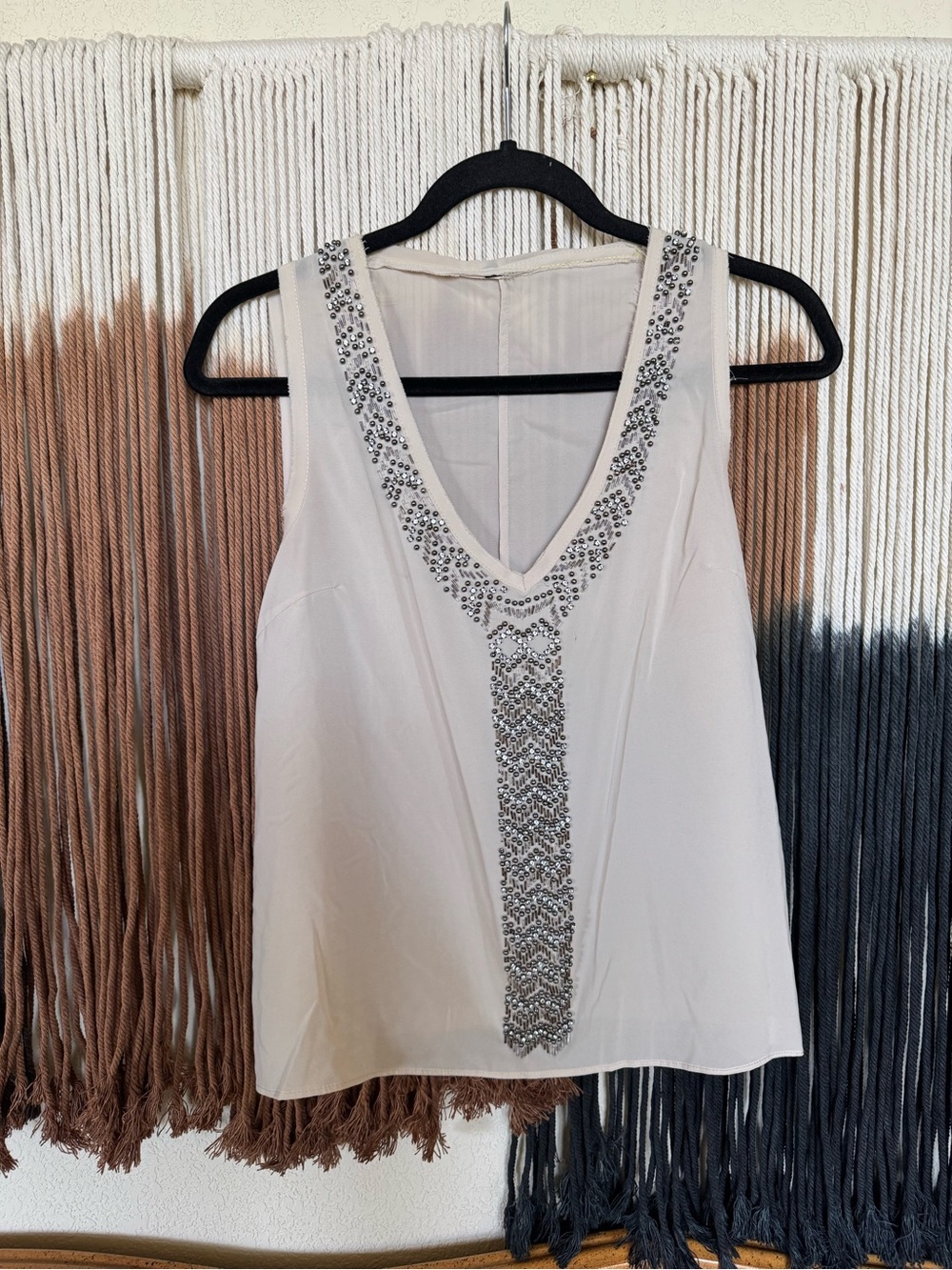 Cream sheer top with silver and bronze sequin details; excellent condition